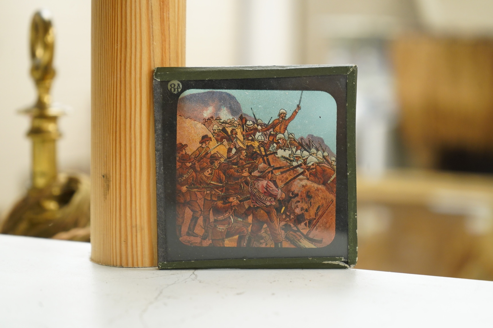 A group of sixteen Zulu War related magic lantern slides, plus some related contemporary newspaper cuttings pasted onto board referring to Rorke’s Drift